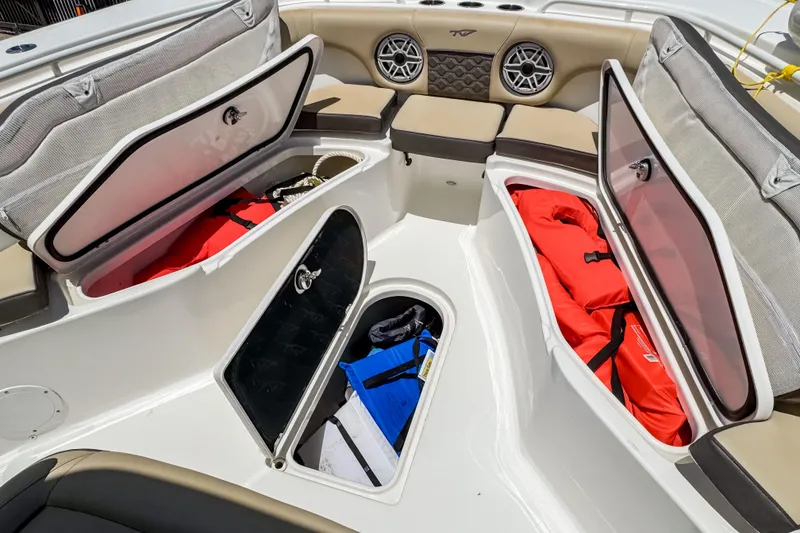 Slide: The Image of 2023 Tidewater 280 CC Adventure boat storage compartments with life jackets and gear. - 32
