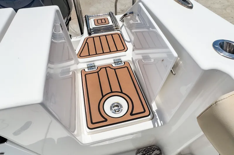 Slide: The Image of 2023 Tidewater 280 CC Adventure boat deck with teak-style flooring and stainless steel fixtures. - 37