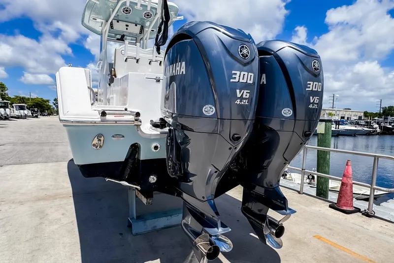 Slide: The Image of 2023 Tidewater 280 CC Adventure with twin Yamaha 300 V6 engines at a marina. - 4