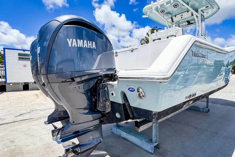 Slide: The Image of 2023 Tidewater 280 CC Adventure boat with Yamaha engine, displayed outdoors under blue sky. - 5