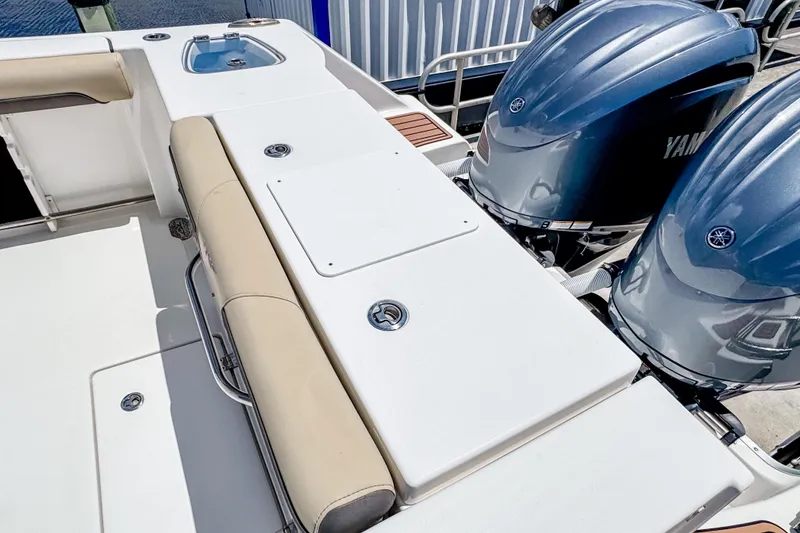 Slide: The Image of 2023 Tidewater 280 CC Adventure boat with dual Yamaha engines and cushioned seating. - 8