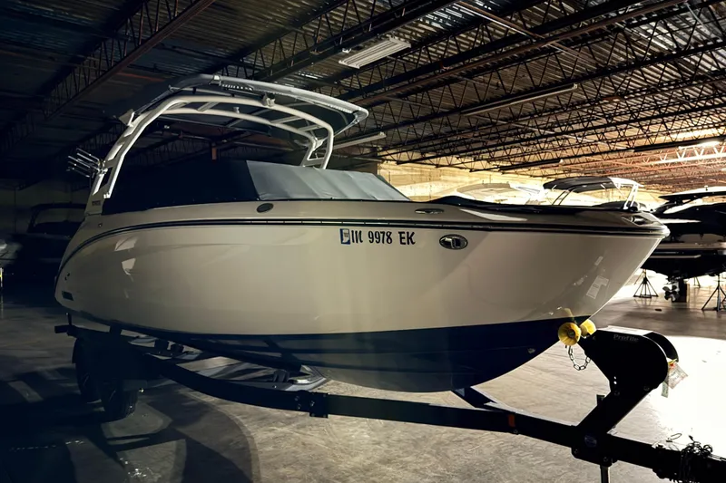Slide: The Image of 2023 Yamaha Boats 252SE in a dimly lit indoor storage facility. - 2