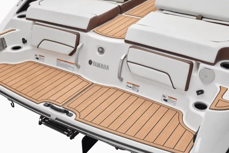 Slide: The Image of 2023 Yamaha Boats 252SE swim platform with teak-style decking and seating. - 6