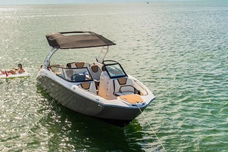 Slide: The Image of 2023 Yamaha Boats 252SE on calm water, featuring sleek design and spacious seating. - 8