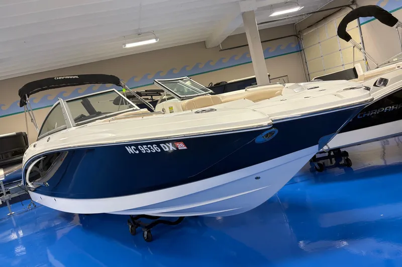 The Image of 2012 Chaparral 244 Sunesta boat displayed indoors on a blue floor. - 0