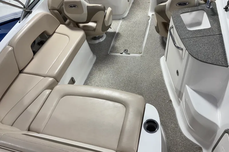Slide: The Image of Interior of 2012 Chaparral 244 Sunesta boat with beige seating and compact sink area. - 4