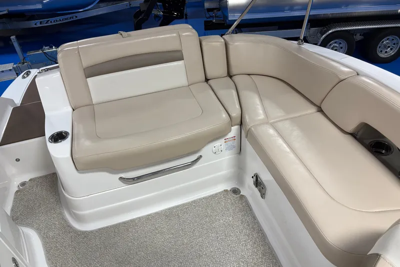 Slide: The Image of 2012 Chaparral 244 Sunesta boat interior with beige seating and cup holders. - 5
