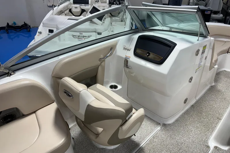 Slide: The Image of Interior of a 2012 Chaparral 244 Sunesta boat with beige seating and modern dashboard. - 7