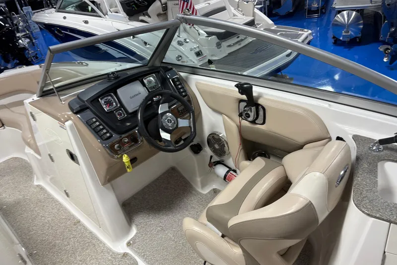 Slide: The Image of 2012 Chaparral 244 Sunesta boat cockpit with steering wheel and navigation system. - 8