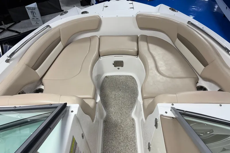 Slide: The Image of 2012 Chaparral 244 Sunesta boat interior with beige seating and carpeted floor. - 9