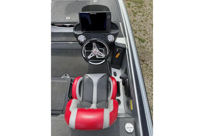 Slide: The Image of 2019 Phoenix 920 ProXP boat cockpit with steering wheel, gauges, and red-gray seat. - 6