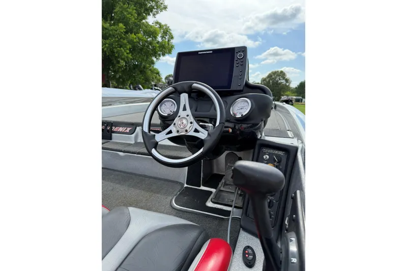 Slide: The Image of 2019 Phoenix 920 ProXP boat dashboard with steering wheel and navigation display. - 7