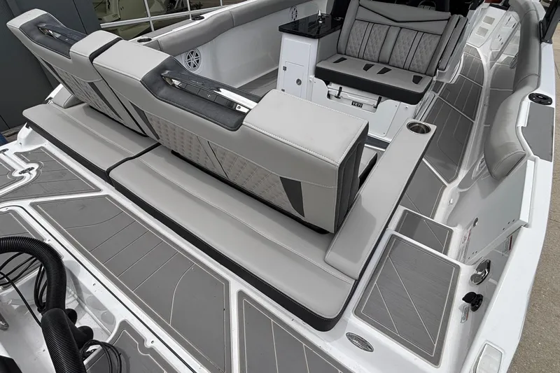 Slide: The Image of Luxurious seating on 2026 Monterey Elite 30 OB boat, featuring sleek gray upholstery. - 11