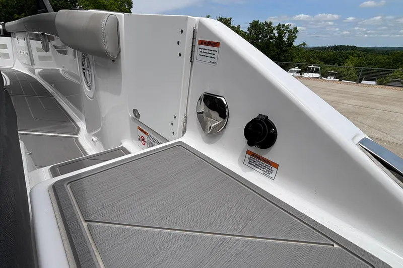 Slide: The Image of 2026 Monterey Elite 30 OB boat deck with sleek design and safety warnings. - 13