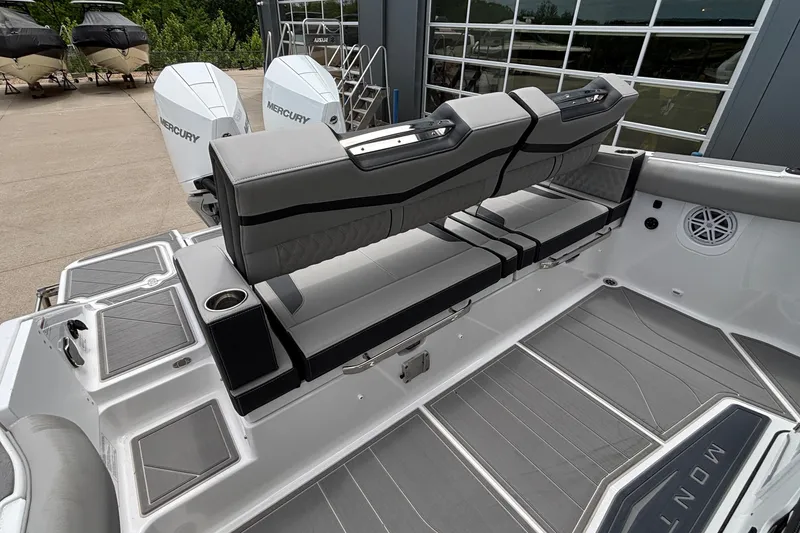 Slide: The Image of 2026 Monterey Elite 30 OB boat interior with seating and Mercury outboard engines. - 19