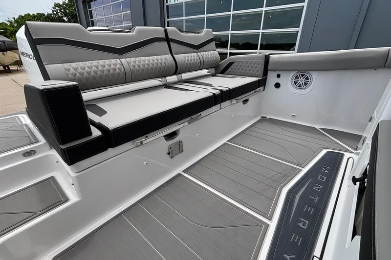 Slide: The Image of 2026 Monterey Elite 30 OB boat interior with sleek seating and modern design. - 21