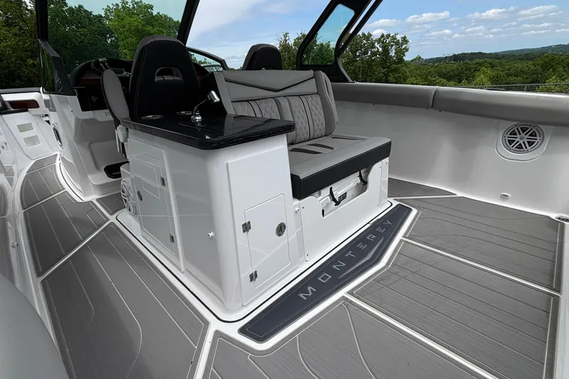 Slide: The Image of 2026 Monterey Elite 30 OB boat interior with sleek seating and modern design. - 23