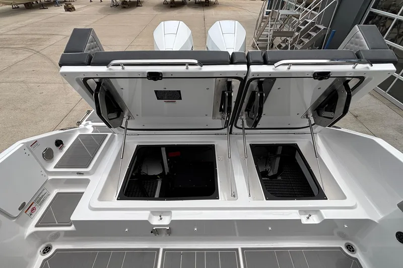 Slide: The Image of 2026 Monterey Elite 30 OB boat with open storage compartments and sleek design. - 24