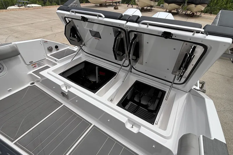 Slide: The Image of 2026 Monterey Elite 30 OB boat with open storage compartments on deck. - 27