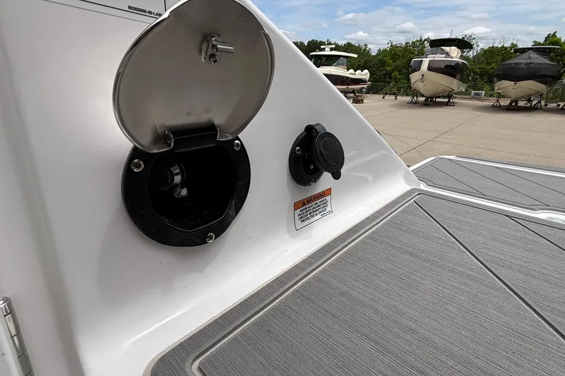 Slide: The Image of Fuel port on 2026 Monterey Elite 30 OB boat, docked with other vessels in background. - 28