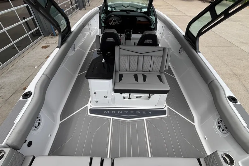 Slide: The Image of 2026 Monterey Elite 30 OB boat interior with sleek seating and modern design. - 30