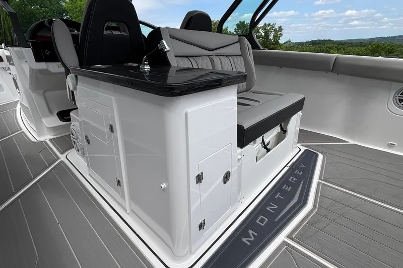 Slide: The Image of 2026 Monterey Elite 30 OB boat interior with sleek seating and modern design. - 33