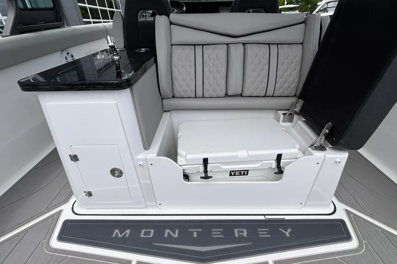 Slide: The Image of Interior of 2026 Monterey Elite 30 OB boat with seating and Yeti cooler storage. - 35