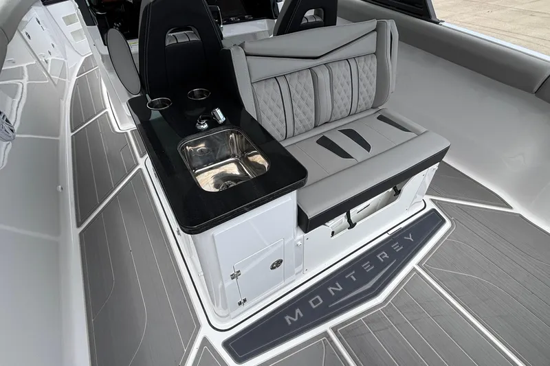 Slide: The Image of 2026 Monterey Elite 30 OB boat interior with sleek seating and built-in sink. - 36