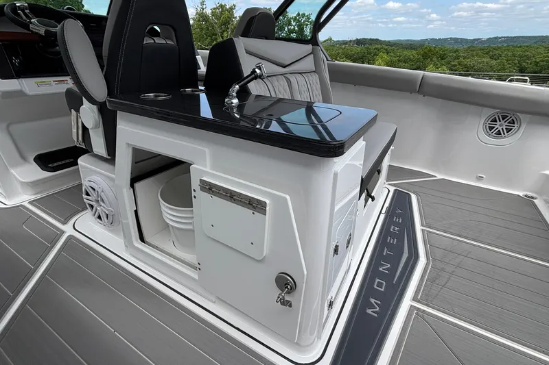 Slide: The Image of Interior of 2026 Monterey Elite 30 OB boat with sleek seating and modern amenities. - 38