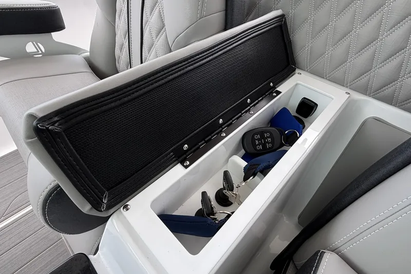 Slide: The Image of 2026 Monterey Elite 30 OB boat storage compartment with keys and accessories. - 43