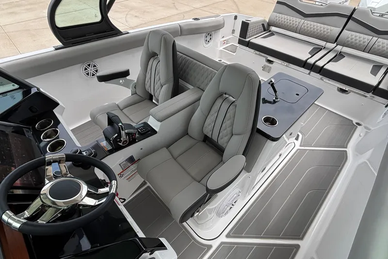 Slide: The Image of Luxurious interior of 2026 Monterey Elite 30 OB boat with modern seating and controls. - 44