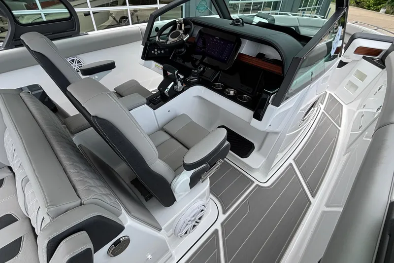 Slide: The Image of Interior of 2026 Monterey Elite 30 OB boat with modern helm and seating. - 45