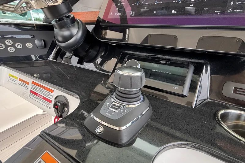Slide: The Image of Control panel of 2026 Monterey Elite 30 OB boat with joystick and display. - 49