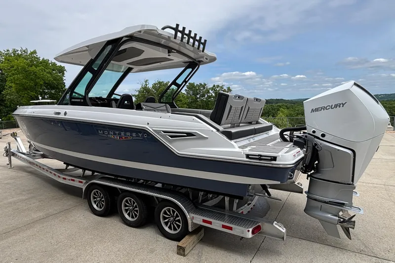 Slide: The Image of 2026 Monterey Elite 30 OB boat on trailer with Mercury outboard motor. - 5