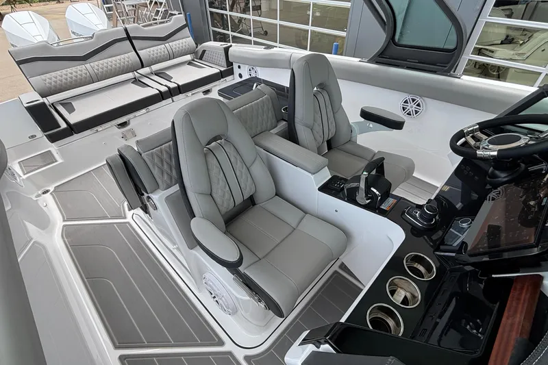 Slide: The Image of Luxurious interior of 2026 Monterey Elite 30 OB boat with plush seating and modern controls. - 50