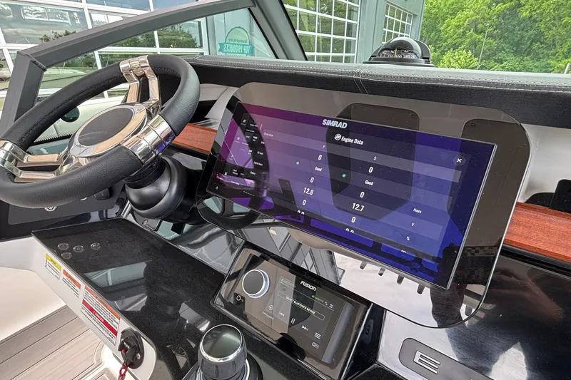 Slide: The Image of Helm of 2026 Monterey Elite 30 OB with advanced Simrad display and controls. - 52