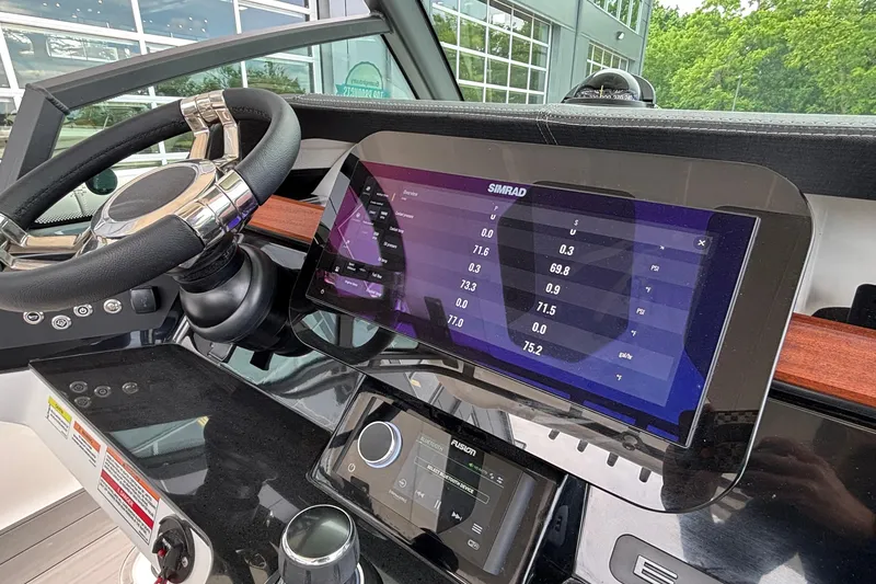 Slide: The Image of Dashboard of 2026 Monterey Elite 30 OB boat with Simrad display and steering wheel. - 53
