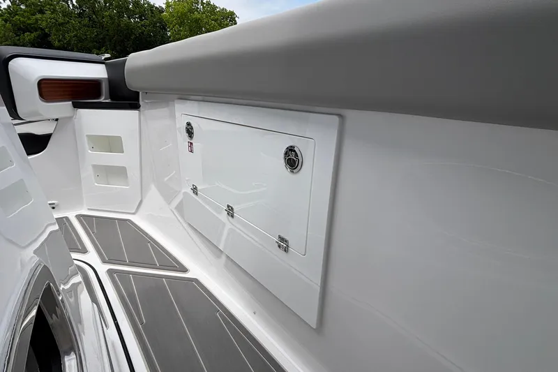 Slide: The Image of 2026 Monterey Elite 30 OB boat interior with sleek white paneling and modern design. - 55
