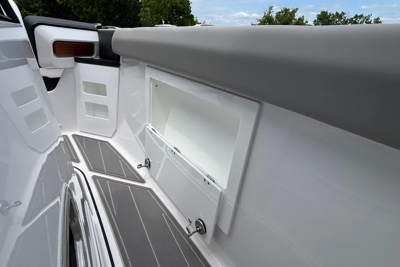 Slide: The Image of Interior view of 2026 Monterey Elite 30 OB boat, featuring sleek storage compartments and modern design. - 56