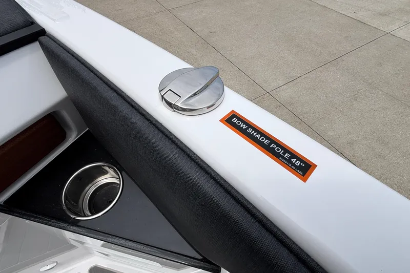 Slide: The Image of 2026 Monterey Elite 30 OB boat detail with bow shade pole label and cup holder. - 59