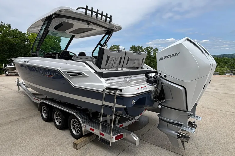 Slide: The Image of 2026 Monterey Elite 30 OB boat with Mercury outboard engine on a trailer. - 6