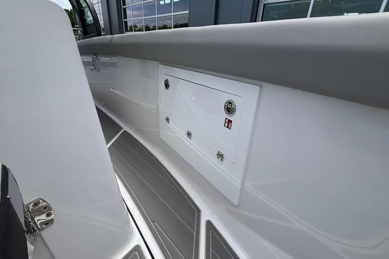 Slide: The Image of Interior view of 2026 Monterey Elite 30 OB boat, featuring sleek design and storage compartment. - 61