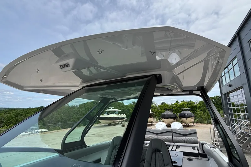 Slide: The Image of 2026 Monterey Elite 30 OB boat with sleek design and modern features, docked outdoors. - 64