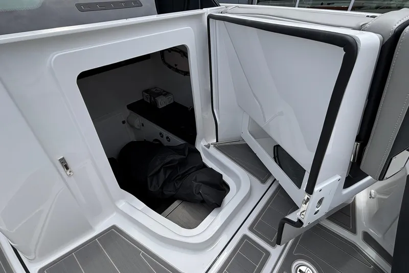 Slide: The Image of Open storage compartment on a 2026 Monterey Elite 30 OB boat, showcasing interior space. - 65