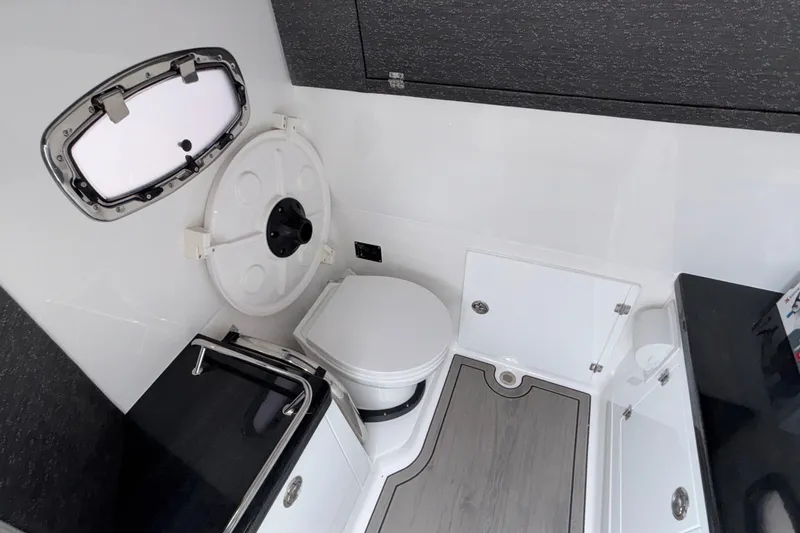Slide: The Image of Modern bathroom interior of 2026 Monterey Elite 30 OB boat, featuring sleek design and compact amenities. - 68