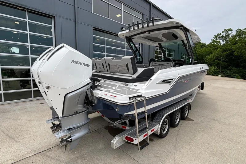 Slide: The Image of 2026 Monterey Elite 30 OB boat with Mercury outboard engine on a trailer. - 7
