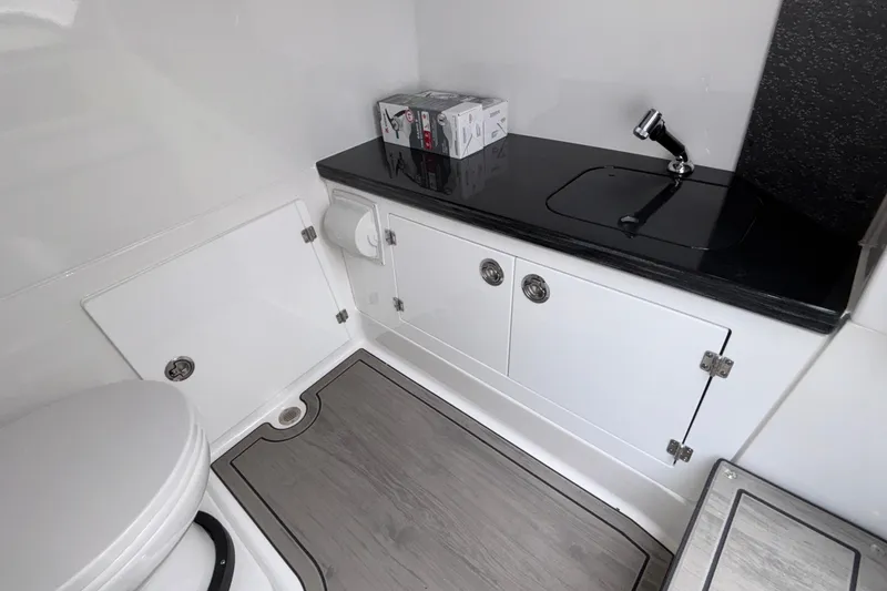 Slide: The Image of Luxurious bathroom in 2026 Monterey Elite 30 OB boat with sleek sink and storage. - 70