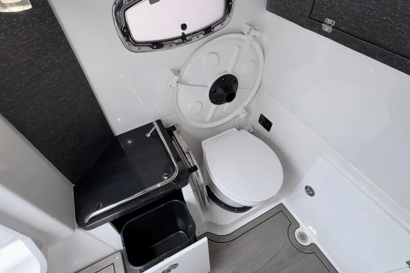 Slide: The Image of 2026 Monterey Elite 30 OB boat bathroom with modern fixtures and compact design. - 76