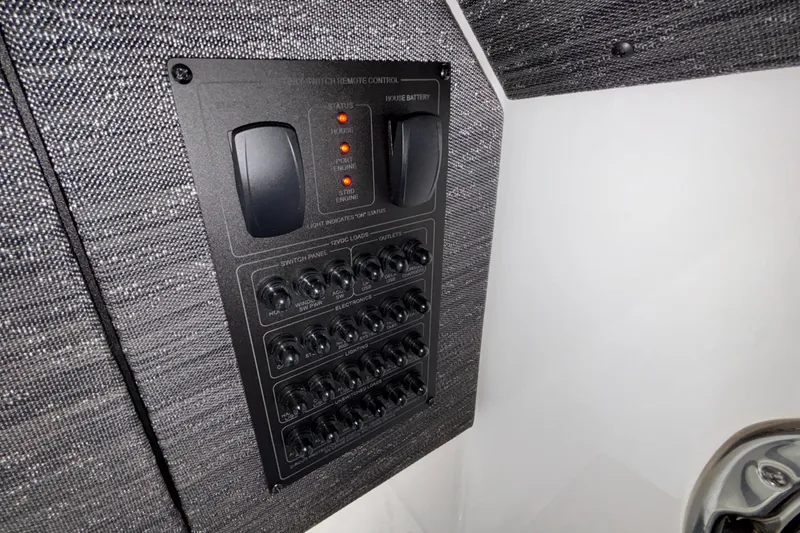 Slide: The Image of Control panel of 2026 Monterey Elite 30 OB boat, featuring switches and indicators. - 78