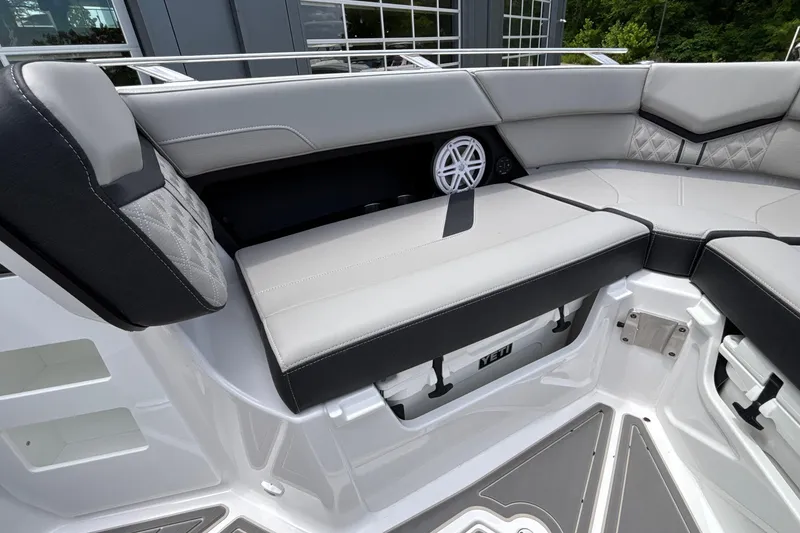 Slide: The Image of Luxurious seating area on the 2026 Monterey Elite 30 OB boat, featuring sleek design and storage. - 81